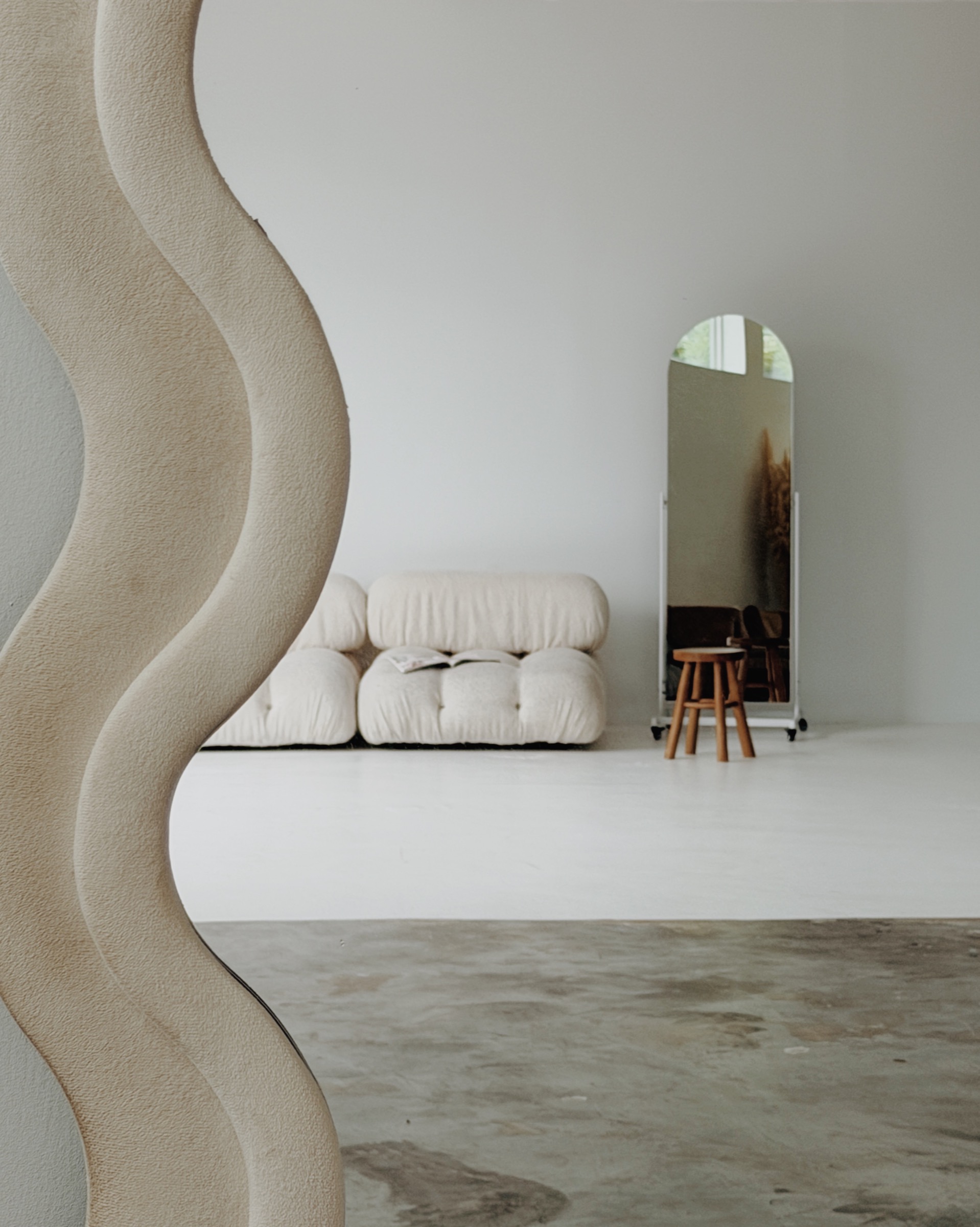 Open studio floor with white walls, polished concrete, and seating